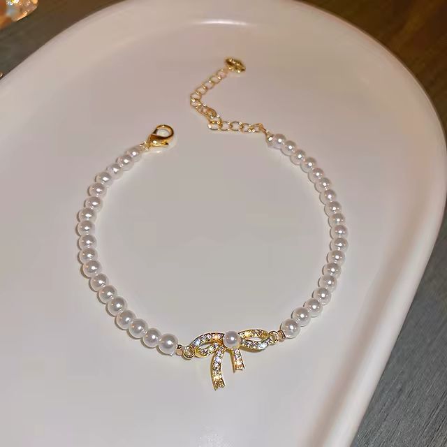 Pulsera perlas con moño circonia